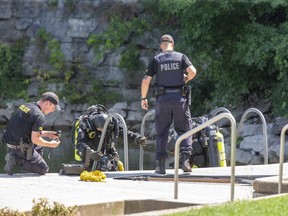OPP divers enter the St. Marys Quarry Monday, Aug. 24, to resume the search for a Kitchener-Waterloo man, 63, who went missing while snorkelling at the popular municipal swimming area Sunday night. (Derek Ruttan/The London Free Press)