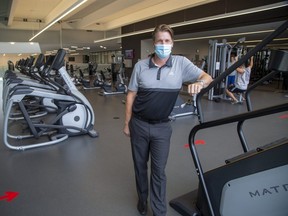 Mike Ennis, YMCA of Southwestern Ontario chief operating officer, shows the modified workout area at the Y's Bostwick Community Centre location. (Derek Ruttan/The London Free Press)