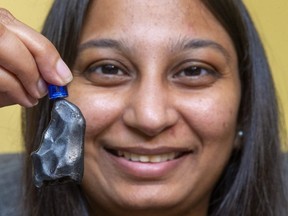 Western University's Parshati Patel, who works at the Institute for Earth and Space Exploration, holds up an iron meteorite with a small magnet. Patel talks about the Perseid meteor showers that will peak tonight, but continue through the week in the night skies over London. (Mike Hensen/The London Free Press)