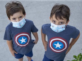 Youngsters like twins Joaquin and Dante Bagur, 4, will have to mask up to help contain COVID-19 when school resumes next month, after trustees of two London-area school boards met in  marathon online sessions Tuesday, August 25. (Derek Ruttan/The London Free Press)