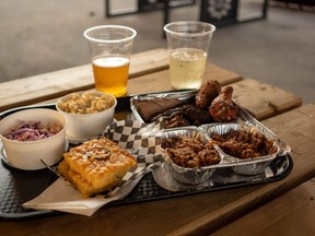 The barbecue meat platter, combining beef brisket, pulled pork, chicken wings and all the classic sides, is king of the menu at Powerhouse Brewing Co. in London. (Max Martin/The London Free Press)