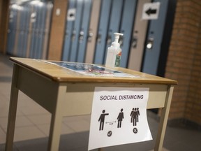Social distancing reminders and hand sanitizer stations are erected throughout St. Thomas of Villanova Catholic High School, as schools prepare to return in September during the COVID-19 pandemic, Thursday, August 6, 2020. (DAX MELMER/Postmedia Network)