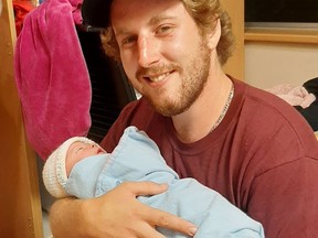 Clayton Ball holds his son Briar, who is just shy of three months old. The 24-year-old Sarnia native was injured in a hit-and-run crash just after midnight Friday. Handout/Sarnia Observer/Postmedia Network