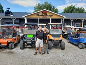 Dimitar Ljomov, left, a chef at Bob ‘n Buoys Bar & Boil in Mitchell’s Bay on Lake St. Clair, and restaurant manager Sherrie Dawson are flanked by golf cart owners. A petition is circulating in Mitchell’s Bay calling on Chatham-Kent council to allow golf carts on local roads. (Handout)