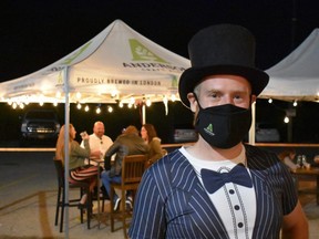 Brewmaster Gavin Anderson adds a formal touch greeting diners at outdoor tables during Anderson Craft Ale's fourth birthday party on Aug. 29. The usual beer festival marking Anderson's annual milestone couldn't happen because of the pandemic, so it was revamped as a four-course sit-down meal by EatOA and an open bar featuring more than 25 beers and craft sodas by Anderson, fellow London brewers, as well as out-of-towners. 
(Barbara Taylor/The London Free Press)