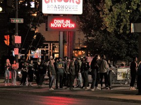 Young people line up outside a Richmond Row bar on Sunday, Sept. 6. London police launched Project Learn, an annual crackdown on rowdy behaviour in neighbourhoods around Western University, Fanshawe College and downtown. DALE CARRUTHERS / THE LONDON FREE PRESS