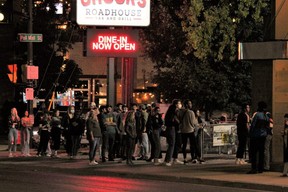 Young people line up outside a Richmond Row bar on Sept. 6, 2020. London police are launching Project Learn, an annual crackdown on rowdy behaviour in neighbourhoods around Western University, Fanshawe College and downtown. (DALE CARRUTHERS/The London Free Press)