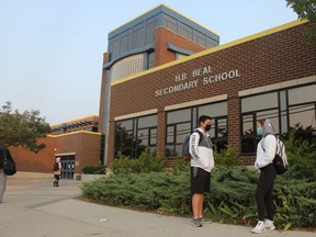 H.B. Beal Grade 10 students Kyle Bethel and Amber Duval talk outside the Dundas Street school Tuesday morning, a day after public health official confirmed a positive COVID-19 test at the high school. JONATHAN JUHA/The London Free Press