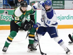 Owen Robinson, right, of the Sudbury Wolves, and Hunter Skinner of the London Knights battle for the puck during during a game Dec. 20, 2019, at the Sudbury Community Arena. (John Lappa/Postmedia Network)