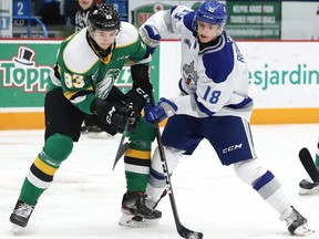 Owen Robinson, right, of the Sudbury Wolves, and Hunter Skinner, of the London Knights, battle for the puck during OHL action at the Sudbury Community Arena in Sudbury, Ont. on Friday December 20, 2019. (John Lappa/Postmedia Network)