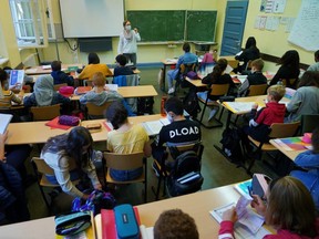 Teacher Julia Rakow wears a protective face mask as she leads a class in the origins of German poetry at Sophie-Charlotte Gymnasium high school during the coronavirus pandemic on Thursday n Berlin, Germany. (Sean Gallup/Getty Images)