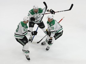 Dallas Stars right wing Corey Perry (10) celebrates with defenseman Esa Lindell (23) and defenseman John Klingberg (3) after scoring the game-winning goal against the Tampa Bay Lightning during the second overtime in game five of the 2020 Stanley Cup Final at Rogers Place: Perry Nelson-USA TODAY Sports