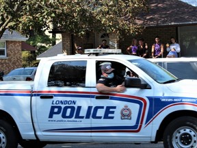 A London police truck drives down Broughdale Avenue, where small groups of students gathered on porches and front lawns to celebrate FoCo last Saturday. (DALE CARRUTHERS, The London Free Press)