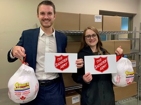 Lewis Kent and Sydney Hussey help donate turkeys to the Salvation Army Centre of Hope on behalf of Sheffar Potter Muchan.