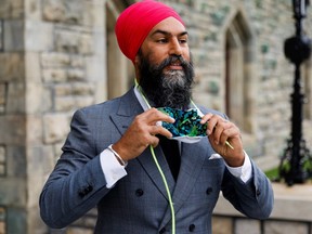 New Democratic Party leader Jagmeet Singh dons his facemask outside West Block on Parliament Hill in Ottawa, Thursday, Sept. 24, 2020.