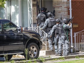 London and provincial police executed a warrant on a house at 596 Regent St., just west of Adelaide Street, Thursday morning. (Derek Ruttan/The London Free Press)