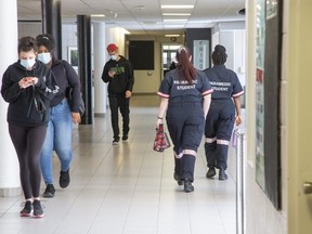 Students walk the halls of Fanshawe College in London on Sept. 21, 2020. The college said Thursday it will shift more classes online in January and require staff to work at home where possible to try to slow the spread of the more contagious COVID-19 Omicron variant.  (Derek Ruttan/The London Free Press)