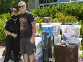 Kevin Harris of Harriston gives a hug Thursday to Praewa Kiatsrithanakorn, an exchange student who has lived in the Harris home for three years, and is now starting school at Western University in London. (Mike Hensen/The London Free Press)