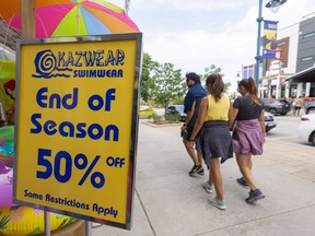 Riz Sheikh, left, with his daughter Ciela, 13, and wife Tracy, of Mississauga walk the retail strip in Grand Bend on Labour Day Monday Sept. 7, 2020. Unlike cities and hard-hit tourist areas, employment numbers in rural Ontario are almost back to pre-pandemic numbers. (Mike Hensen/The London Free Press)(Mike Hensen/The London Free Press)