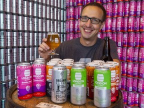 Aaron Lawrence the head brewer at London Brewing shows off their organic beers in London.  (Mike Hensen/The London Free Press)