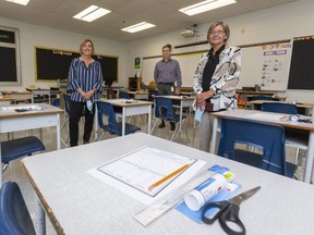 Principal Liz Greve, manager of custodial services Curtis McGee and the London Distric Catholic school board director of education Linda Staudt stand in one of the classrooms at St. Francis elementary school in London in the days before children returned to class in September. Staudt and her public-board counterpart acknowledge the return to school has been difficult for many.  (Mike Hensen/The London Free Press)