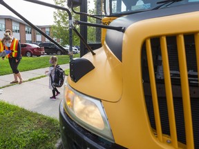 A returning pupil steps off the school bus at Lord Nelson elementary school in east London.
Photograph taken on Monday September 14, 2020. 
Mike Hensen/The London Free Press/Postmedia Network