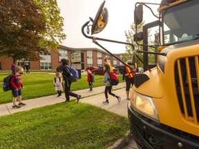 Students at Lord Nelson public school in London hop off the bus Monday to attend senior kindergarten. (Mike Hensen/The London Free Press)