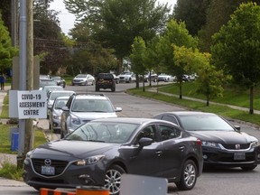 A huge lineup snaked down Valetta Street as Londoner waited to be tested at the Oakridge Arena Covid-19 assessment centre. The wait was several hours long. (Mike Hensen/The London Free Press)