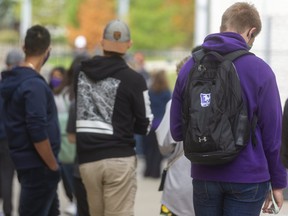 A long line of Western University students waits to be seen at the COVID-19 on-campus assessment centre that opened Monday morning. By noon, it had reached its capacity of 220 tests, so several people waiting must return Tuesday. Photo taken on Monday September 14, 2020. (Mike Hensen/The London Free Press)