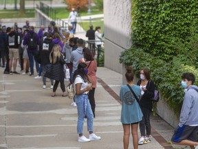 A long line of Western students wait to be assessed at the COVID-19 on campus assessment centre that opened at 11am on Monday.  (Mike Hensen/The London Free Press)