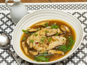 Poached cod with a rich broth garnished with spinach and green onion makes a delicious transition to fall cuisine, says food columnist Jill Wilcox. (Mike Hensen/The London Free Press)