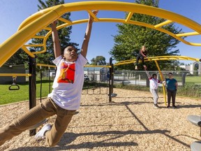 Muaz Mohamed, 10, of Lord Elgin public school shows his mastery of the bars that form part of the new playground equipment installed at the school. Photograph taken on Friday, Sept. 18, 2020.  (Mike Hensen/The London Free Press)