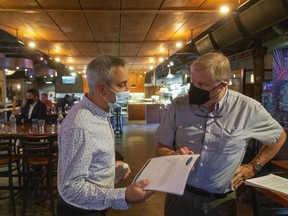 Jerry Pribil, owner of the Marienbad and Chaucer's, talks with fellow restaurateur Mike Smith at Toboggan Brewing Company on Richmond Street as small business people met to discuss strategies to deal with the coronavirus pandemic.  (Mike Hensen/The London Free Press)