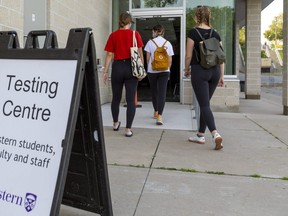 Three Western students enter the mobile COVID-19 test centre on campus, in its new home at the Western Student Recreation Centre, on Monday, Sept. 28. (Mike Hensen/The London Free Press)