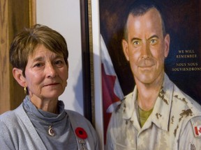 Carolyn Wilson lost her son, Trooper Mark Wilson, in Afghanistan in 2006. She's pictured here next to his portrait, in 2010. (Mike Hensen/The London Free Press)