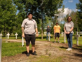 Katie Bast, Wayne Barnett, Liam Sert and Sarah Duplisea of Peacekeeper's Park wonder where they will move hundreds of memorial crosses for fallen Canadian peacekeepers after Kettle Creek Conservation Authority said it will not renew the park's lease when it expires at the end of this year. (MAX MARTIN, The London Free Press)