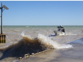 The OPP Search and Recovery boat returns to Port Glasgow harbour during rough conditions with high waves and rough water conditions on Sunday on Lake Erie southwest of London, Ont. (Mike Hensen/The London Free Press)