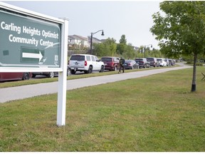 Very long line up at the Carling Heights Optimist Community Centre COVID-19 Assessement Centre in London. (Derek Ruttan/The London Free Press)