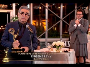 This handout picture released courtesy of Image Group LA / American Broadcasting Companies, Inc. / ABC shows host Canadian actor Eugene Levy speaks after receiving his Emmy while his son actor/director/writer Daniel Levy watches during the 72nd Primetime Emmy Awards ceremony held virtually on September 20, 2020.