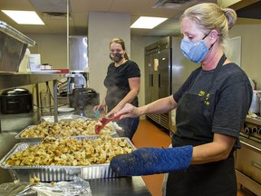 The Blessing Centre directors Kari Morrow (left) and Linda Persall help prepare a Thanksgiving dinner for people less fortunate in Brantford, Ont., Oct. 12, 2020.