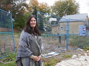 Karen Fisher, whose home at 450 Woodman Ave. was destroyed last year in the Old East Village explosion, stands in front of the empty blast site, where she's hoping to build a new home for herself and her daughter Emma. (JONATHAN JUHA/The London Free Press)