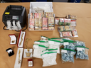 Among items seized by police during searches Wednesday of two London homes and two vehicles are a money counter, $100,000 in cash, 1.2 kilograms of suspected fentanyl worth $306,000, 1.7 kilograms of suspected methamphetamine valued at $153,000 and gold jewelry valued at $100,000. (Police supplied photo)