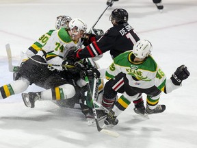 Jonah De Simone of the Niagara Ice Dogs takes out three London Knights players (L TO R Brett Brochu, Ben Roger and Gerard Keane) with one check during the first period of their OHL hockey game at Budweiser Gardens. (Derek Ruttan/The London Free Press file photo)