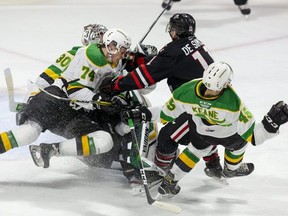Jonah De Simone of the Niagara Ice Dogs takes out three London Knights players (L TO R Brett Brochu, Ben Roger and Gerard Keane) with one check during the first period of their OHL hockey game at Budweiser Gardens. (Derek Ruttan/The London Free Press file photo)