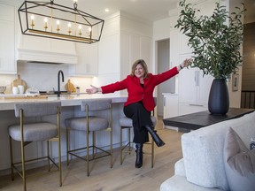 Michelle Campbell, president and CEO of the St. Jospeh's Health Care Foundation, sits at the large island in the kitchen  at 20 Edgeview Cres. in Kilworth on Thursday Oct. 1, 2020. Virtual tours of the homes are possible on the Dream Lottery website. (Derek Ruttan/The London Free Press)