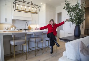 Michelle Campbell, president and CEO of the St. Jospeh's Health Care Foundation, sits at the large island in the kitchen  at 20 Edgeview Cres. in Kilworth on Thursday Oct. 1, 2020. Virtual tours of the homes are possible on the Dream Lottery website. (Derek Ruttan/The London Free Press)