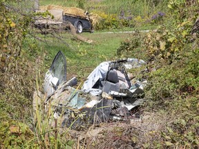 A woman was flown to hospital with critical injuries after the car she was driving left Mt. Carmel Drive, crashed into a grove and caught fire east of Grand Bend Road near Mt. Carmel Thursday, Oct. 1. (Derek Ruttan/The London Free Press)