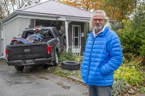 Hubert Van Niekerk stands in front of his rental property at 30 Elliot St. in London on Monday October 19, 2020. Nobody was inside the east-end house when it was struck by a stolen pickup truck Monday morning, police say.