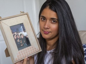 London's Jessica Bencosme is taking part in a new federal immigration lottery that will determine whether she can apply to sponsor her widowed mother, Maria Francisca, whose picture she holds, to Canada from the Dominican Republic. (Mike Hensen/The London Free Press)