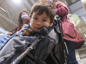Colin Salvati, 2, checks out the camera while his mom Lynn Lan and friend Kendra Cowan talk about their plans for the winter during COVID-19 restrictions in London. Photograph taken on Thursday October 22, 2020. Mike Hensen/The London Free Press/Postmedia Network